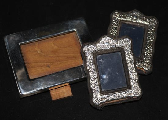 A pair of modern silver photograph frames and a plated frame.